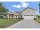Charming two-story home with attached two-car garage and light-colored siding at 1901 Lakeshore Cir, Longwood, FL 32750