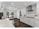 Bright kitchen boasts modern cabinets, stainless steel appliances, a bay window, and unique flooring at 1901 Lakeshore Cir, Longwood, FL 32750