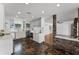 Open kitchen with stainless appliances, marble counters, and unique tile flooring adjacent to the living room at 1901 Lakeshore Cir, Longwood, FL 32750