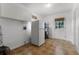 Functional laundry room with tiled floors, white cabinets, and a door to the backyard at 1901 Lakeshore Cir, Longwood, FL 32750