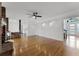 Open living room with hardwood floors and recessed lighting leading to a dining and kitchen area at 1901 Lakeshore Cir, Longwood, FL 32750