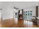 Bright living room with hardwood floors, fireplace, ceiling fan, and sliding glass doors to the outside at 1901 Lakeshore Cir, Longwood, FL 32750
