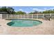 Sparkling pool surrounded by a brick patio and a privacy fence, creating an ideal backyard oasis at 1901 Lakeshore Cir, Longwood, FL 32750