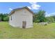 Well-maintained backyard shed with double doors, offering ample storage and a neatly kept lawn at 1901 Lakeshore Cir, Longwood, FL 32750