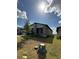 Home exterior, with a view of a young tree planted in the lawn at 2082 Gold Dust Dr, Clermont, FL 34715