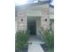 Covered front entry with stone pillars and outdoor lighting at 2082 Gold Dust Dr, Clermont, FL 34715