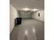 Spacious two-car garage featuring epoxy flooring, lighting and door to interior of the home at 2082 Gold Dust Dr, Clermont, FL 34715