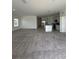 Open-concept living room flows into the modern kitchen at 2082 Gold Dust Dr, Clermont, FL 34715