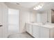 Bathroom with a double vanity and a view into the bedroom area at 2170 Derwent Dr, Davenport, FL 33896
