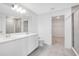 Bright bathroom with double sinks, a walk-in closet, and a glass-enclosed shower at 2170 Derwent Dr, Davenport, FL 33896