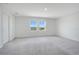 Spacious bedroom featuring neutral carpet, a closet and two windows offering neighborhood views at 2170 Derwent Dr, Davenport, FL 33896