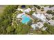 Aerial shot of a resort-style pool area with palm trees, lounge chairs, and a mini golf area at 2170 Derwent Dr, Davenport, FL 33896