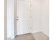 Bright white door with brushed hardware near tile flooring and a simple rug at 2170 Derwent Dr, Davenport, FL 33896