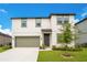 Charming two-story home featuring a manicured lawn, two-car garage, and welcoming front entrance at 2170 Derwent Dr, Davenport, FL 33896
