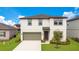 Charming two-story home with a well-manicured lawn at 2170 Derwent Dr, Davenport, FL 33896
