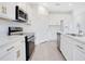 Bright modern kitchen with stainless steel appliances, white cabinets, quartz countertops, and tile flooring at 2170 Derwent Dr, Davenport, FL 33896