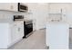 Modern kitchen features white cabinets, stainless steel appliances and a large island with a sink at 2170 Derwent Dr, Davenport, FL 33896