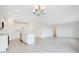 Open-concept kitchen and living area featuring white cabinets, modern appliances, and abundant natural light at 2170 Derwent Dr, Davenport, FL 33896