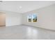 Bright, open-concept living room with modern tile floors and ample natural light from large windows at 2170 Derwent Dr, Davenport, FL 33896