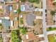 An aerial view showing the house in the neighborhood with pools, roads, and other houses at 2317 Clearwater Dr, Deltona, FL 32738