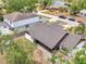 Aerial view of home featuring a screened pool, long driveway, and mature trees at 2317 Clearwater Dr, Deltona, FL 32738