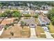 Aerial view of the home featuring a long driveway and mature trees in a neighborhood at 2317 Clearwater Dr, Deltona, FL 32738