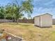 Large backyard includes a storage shed and a spacious grassy area at 2317 Clearwater Dr, Deltona, FL 32738