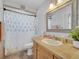 Cozy bathroom with shower and tub combo, white patterned shower curtain, and vanity at 2317 Clearwater Dr, Deltona, FL 32738
