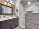 Modern bathroom featuring a double vanity, tiled accents, and a glass-enclosed shower at 2317 Clearwater Dr, Deltona, FL 32738