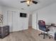 This bedroom offers wood floors, a ceiling fan, and a closet for storage at 2317 Clearwater Dr, Deltona, FL 32738