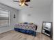 This bedroom features wood floors and a ceiling fan for comfort and style at 2317 Clearwater Dr, Deltona, FL 32738