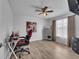 This bedroom features wood floors, a ceiling fan, and bright white walls at 2317 Clearwater Dr, Deltona, FL 32738