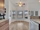Bright dining area with bay windows and kitchen bar featuring granite countertops at 2317 Clearwater Dr, Deltona, FL 32738