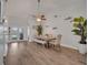 Open-concept dining room with wood floors, a ceiling fan, and a view to the backyard through glass doors at 2317 Clearwater Dr, Deltona, FL 32738