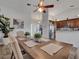 Open-concept dining area with wood floors, featuring a long wooden table and contemporary decor at 2317 Clearwater Dr, Deltona, FL 32738