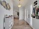 Bright entryway with hardwood floors, a decorative light fixture, and a view into the living spaces at 2317 Clearwater Dr, Deltona, FL 32738