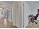 Bright hallway features wood floors, white trim, storage closet, and access to other rooms at 2317 Clearwater Dr, Deltona, FL 32738