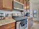 Stylish kitchen features granite countertops, stainless steel range, and ample counter space at 2317 Clearwater Dr, Deltona, FL 32738