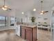 Open kitchen with granite counters, stainless dishwasher, and island sink with view of dining area at 2317 Clearwater Dr, Deltona, FL 32738
