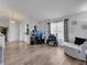 Open-concept living room offers wood flooring, natural light, and access to other living spaces at 2317 Clearwater Dr, Deltona, FL 32738