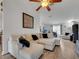 Cozy living room with a comfortable, white couch, neutral color scheme, and bright natural light at 2317 Clearwater Dr, Deltona, FL 32738