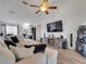 Open living room with a large white sofa, wood floors, TV, and entertainment system at 2317 Clearwater Dr, Deltona, FL 32738