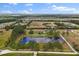 Aerial view showcasing pond surrounded by trees on expansive lot at 240 Spring Forest Dr, New Smyrna Beach, FL 32168