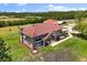 Aerial view of the estate featuring a large brick home, well-manicured lawn, and established landscaping at 240 Spring Forest Dr, New Smyrna Beach, FL 32168