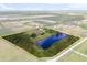 Expansive estate featuring a large private pond and lush landscaping enclosed by a yellow border at 240 Spring Forest Dr, New Smyrna Beach, FL 32168