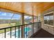 Balcony overlooking pool and patio with a screened enclosure and brick columns at 240 Spring Forest Dr, New Smyrna Beach, FL 32168