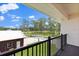 Balcony view of expansive property featuring shed, basketball court, and mature trees at 240 Spring Forest Dr, New Smyrna Beach, FL 32168