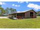 Exterior of barn, with a tractor parked outside at 240 Spring Forest Dr, New Smyrna Beach, FL 32168