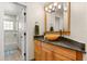 Bathroom with a wooden vanity, granite counters, and a shower at 240 Spring Forest Dr, New Smyrna Beach, FL 32168