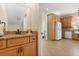 Bathroom featuring granite countertops and light wood cabinetry adjacent to kitchen area at 240 Spring Forest Dr, New Smyrna Beach, FL 32168